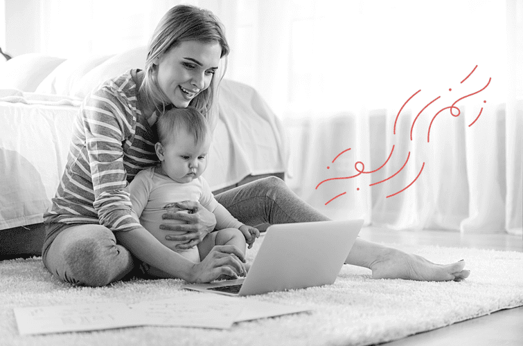 Mother with baby in front of a laptop