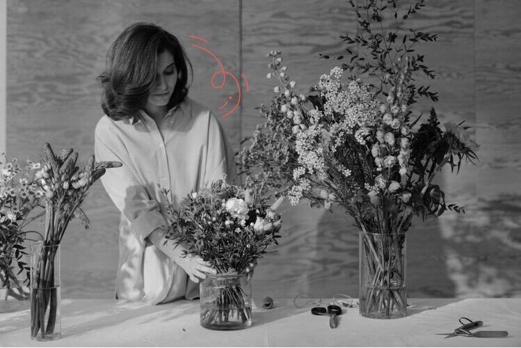 Girl-arranging-flower-vases